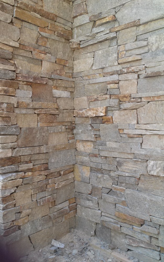 Stone veneer on the first floor, applied by master craftsmen.